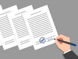 Stack of documents and hand of person wearing business suit, signing and stamping them. Concept of signing of new acts, decrees, agreements, political, legal or business relationships